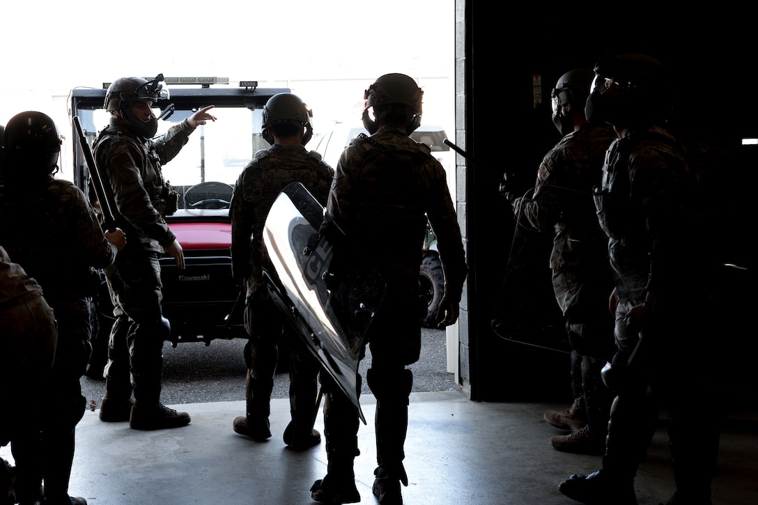 A picture of Airmen standing in riot gear.