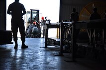 A photo of Airmen picking up a bomb.