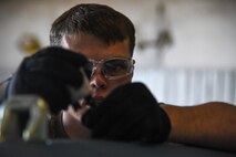 A photo of an Airman connecting a fuse on a bomb.