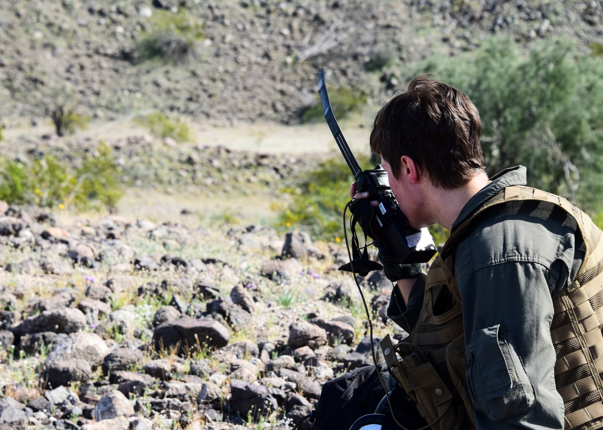 A photo of a Marine simulating an isolated personnel for recovery