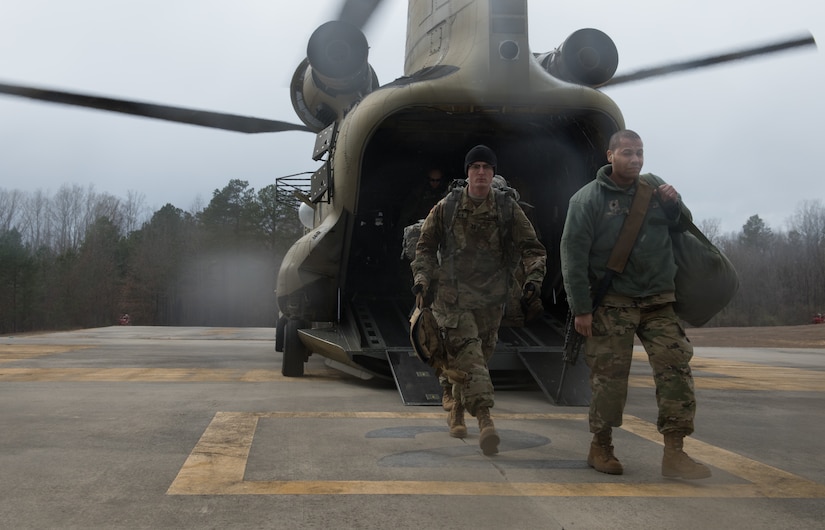 U.S. Army Soldiers exit a CH-47 Chinook helicopter at a training in Wilcox, Virginia, March 6, 2020. The helicopter took off from Felker Army Airfield, Joint Base Langley-Eustis, Virginia. (U.S. Air Force photo by Airman 1st Class Sarah Dowe)