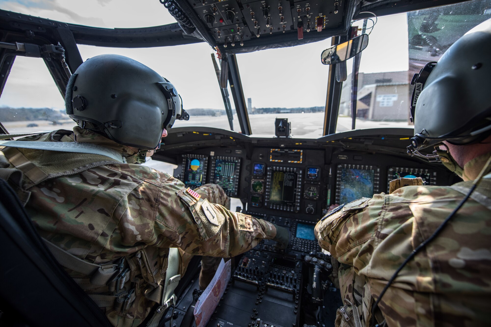 CH-47 Chinook helicopter pilots, Chief Warrant Officer 3 Jesse Bander, Chinook CH-47 pilot 159th General Support Aviation Battalion 244th Bravo Company CH-47 Chinook pilot, and Capt. Cory Moylan, 159th GSAB, 247th Bravo Company commander, perform pre-flight checks prior to taking off from Felker Army Airfield, Joint Base Langley-Eustis, Virginia, March 6, 2020. The pilots regularly support training and real-world flying missions. (U.S. Air Force photo by Senior Airman Anthony Nin Leclerec)