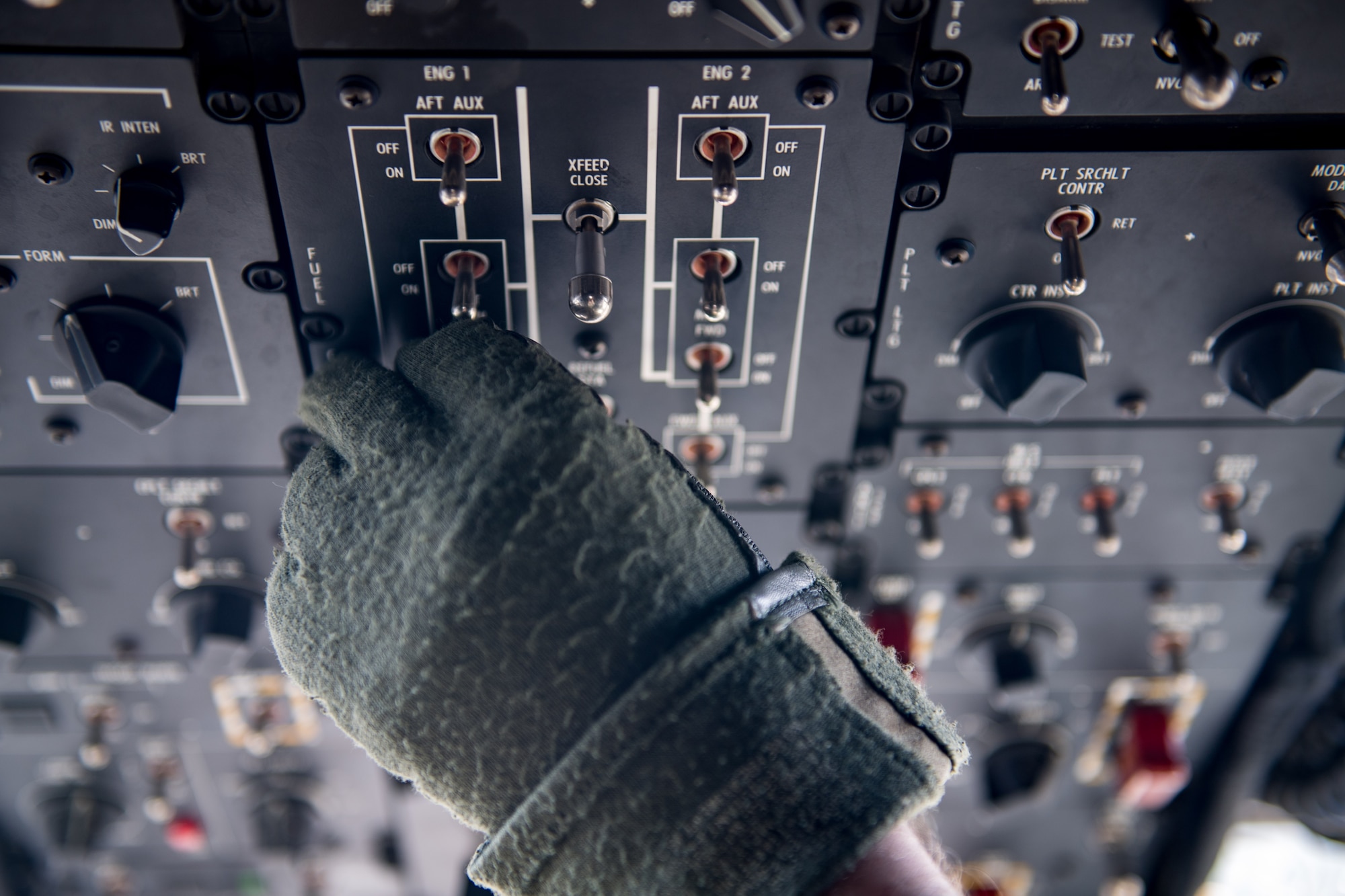 A U.S. Army pilot adjusts switches inside a Chinook CH-47 at Felker Army Airfield, Joint Base Langley-Eustis, Virginia, March 6, 2020. The helicopter transported Army Soldiers to a Field Training Exercise in Wilcox, Virginia. (U.S. Air Force photo by Senior Airman Anthony Nin Leclerec)