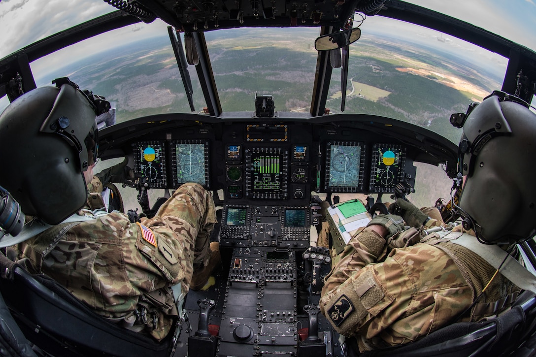 CH-47 Chinook helicopter pilots, Chief Warrant Officer 3 Jesse Bander, 159th General Support Aviation Battalion 244th Bravo Company, and Capt. Cory Moylan, 159th GSAB, 244th Bravo Company commander, fly after taking off from Felker Army Airfield, Joint Base Langley-Eustis, Virginia, March 6, 2020. The pilots regularly help support training and combat missions. (U.S. Air Force photo by Senior Airman Anthony Nin Leclerec)