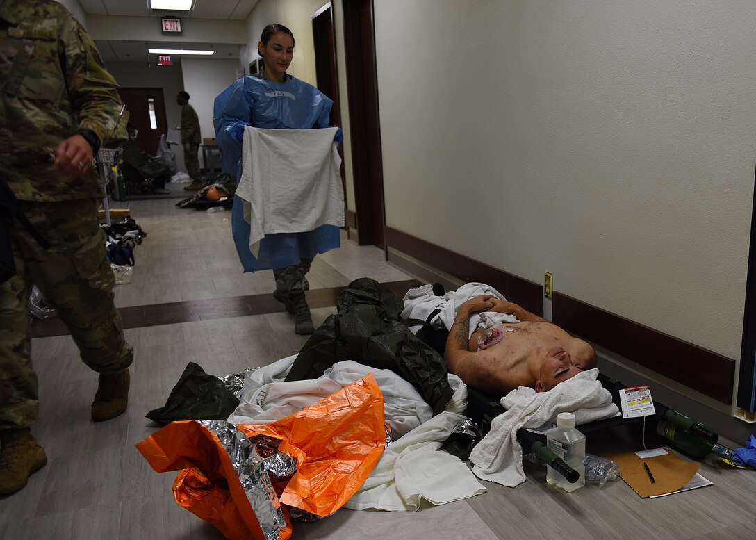 Airman 1st Class Aaron Dorfmeier, 7th Logistics Readiness Squadron aircraft parts store technician, lays in a hallway as a simulated medical patient during the 7th Medical Group’s chemical, biological, radiological, and nuclear exercise at Dyess Air Force Base, Texas, March 6, 2020.