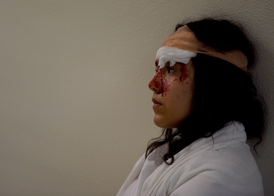 Monica Valencia, Abilene Christian University junior student, awaits further treatment as a simulated patient during the 7th Medical Group’s chemical, biological, radiological, and nuclear exercise at Dyess Air Force Base, Texas, March 6, 2020.