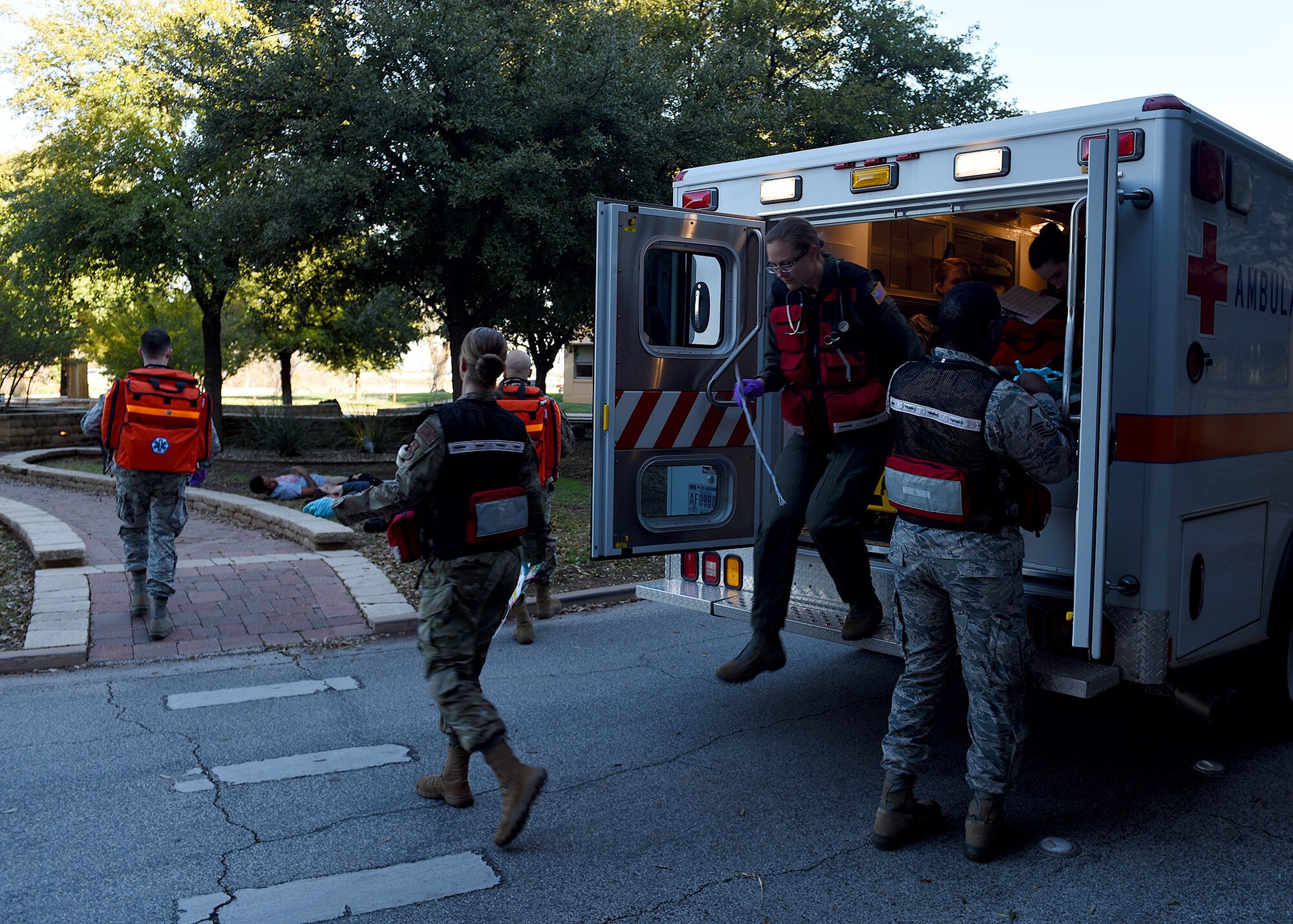 Airmen assigned to the 7th Operational Medical Readiness Squadron jump out of the back of an ambulance during the 7th Medical Group’s chemical, biological, radiological, and nuclear exercise at Dyess Air Force Base, Texas, March 6, 2020.