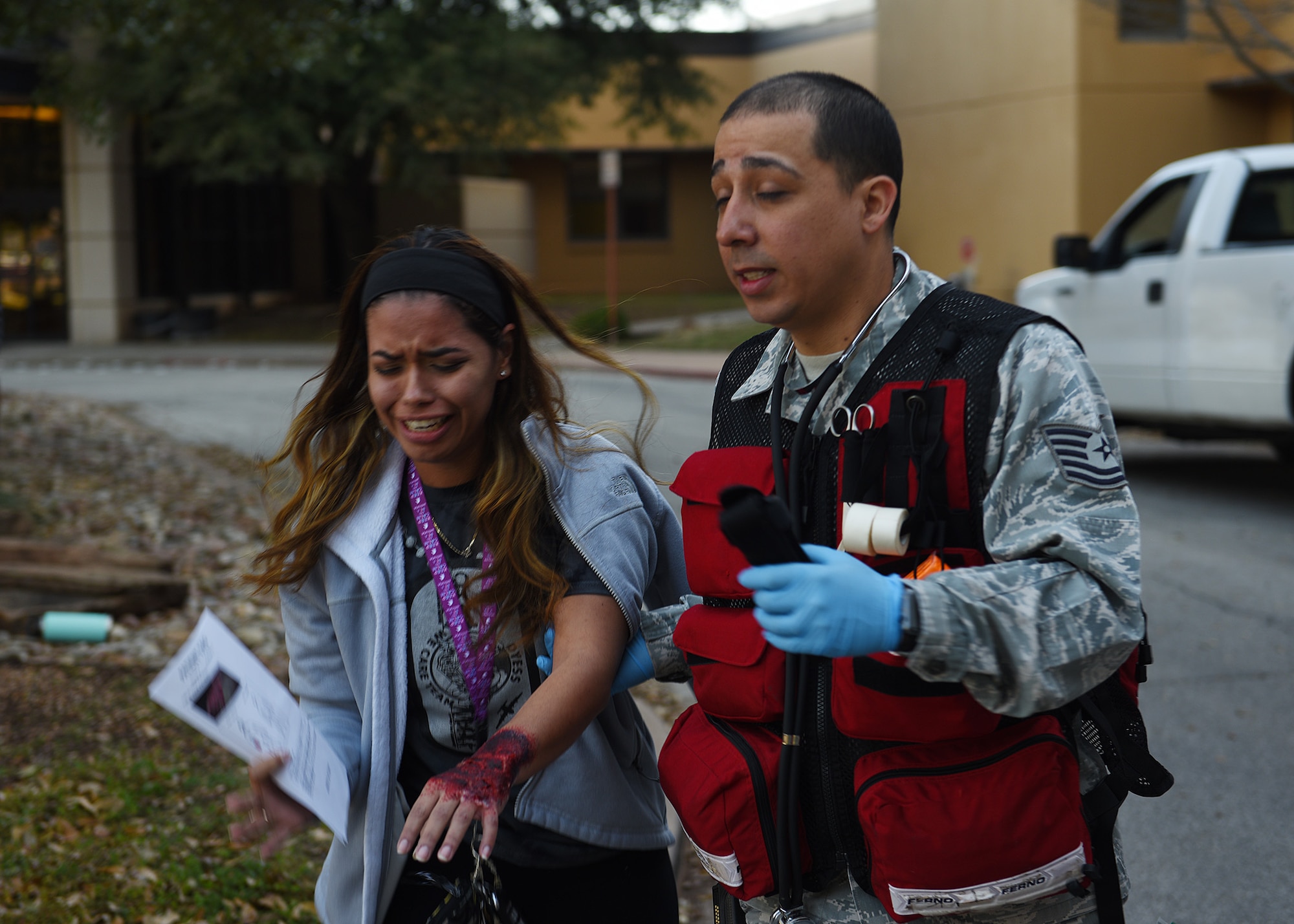 Tech. Sgt. Elliot Lucero, 7th Operational Medical Readiness Squadron noncommissioned officer in charge of the base operational medical cell, escorts Senior Airman Marisol White, 7th Maintenance Group maintenance management production journeyman and simulated injured patient, during the 7th Medical Group’s chemical, biological, radiological, and nuclear exercise at Dyess Air Force Base, Texas, March 6, 2020.