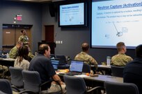 Army Capt. Balazs Bene, Medical Radiology Advisory Team manager, discusses physical principles and health physics basics of ionizing radiation as part of a Medical Effects of Ionizing Radiation (MEIR) course at Joint Task Force Civil Support headquarters.