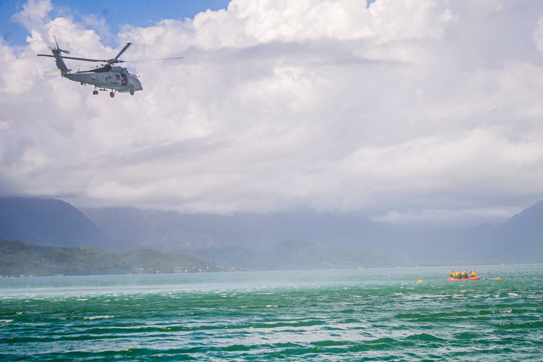 U.S. Marines with Marine Heavy Helicopter Squadron 463 host a mishap drill exercise with Sailors from Helicopter Maritime Strike Squadron 37 using the MH-60R “Sea Hawk” helicopter to hoist Marines out of the bay at Marine Corps Base Hawaii, Mar. 4, 2020. The purpose of the exercise is to make Marines and Sailors more proficient in water rescue operations. (U.S. Marine Corps photo by Lance Cpl. Jacob Wilson)