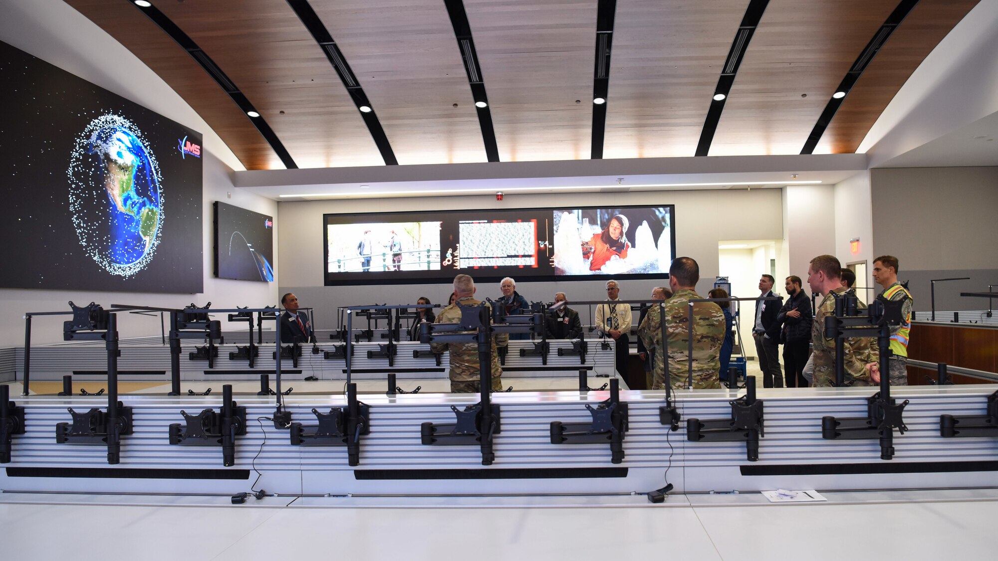 Members of the Governor’s Military Council and base leadership gather during a tour of the operations floor at the new Combined Force Space Component Command headquarters building, March 10, 2020, at Vandenberg AFB. The GMC visited Vandenberg and received in-depth briefings, and saw firsthand how the installation fits into the beginnings of the United States Space Force. (U.S. Air Force photo by Senior Airman Aubree Milks)