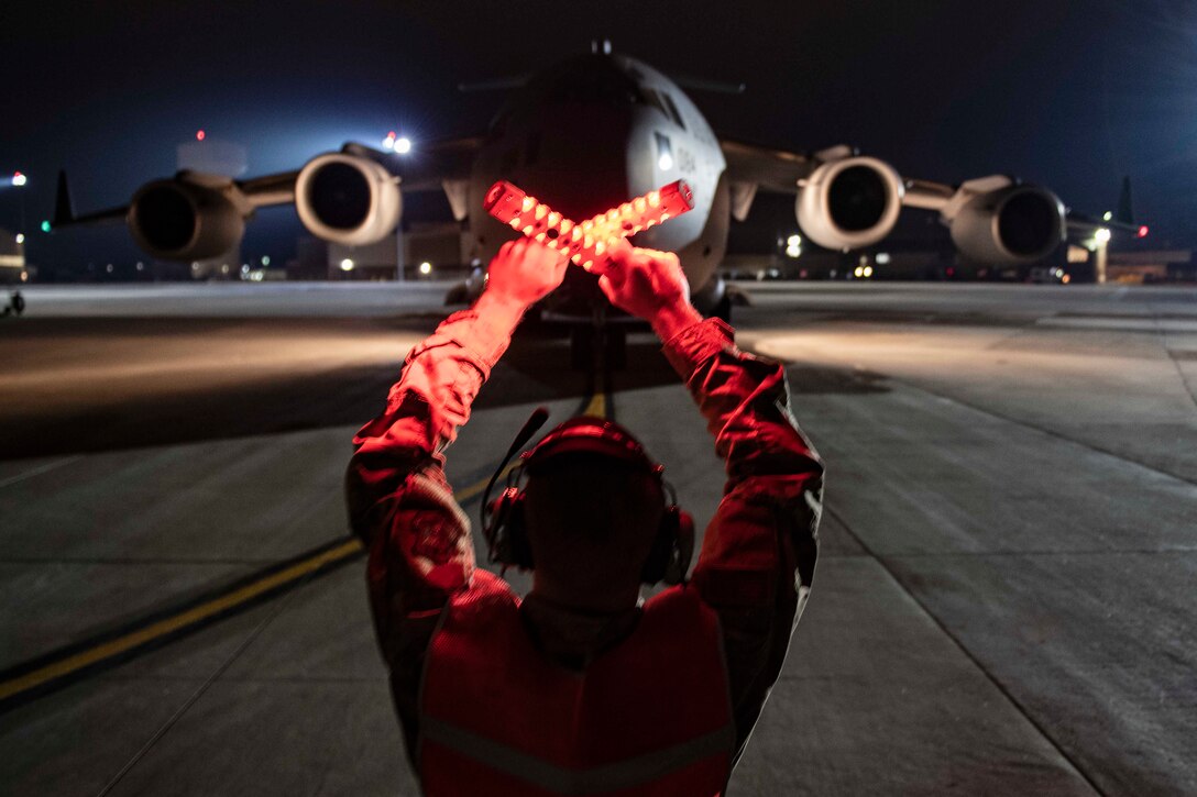 An airman signals an aircraft.