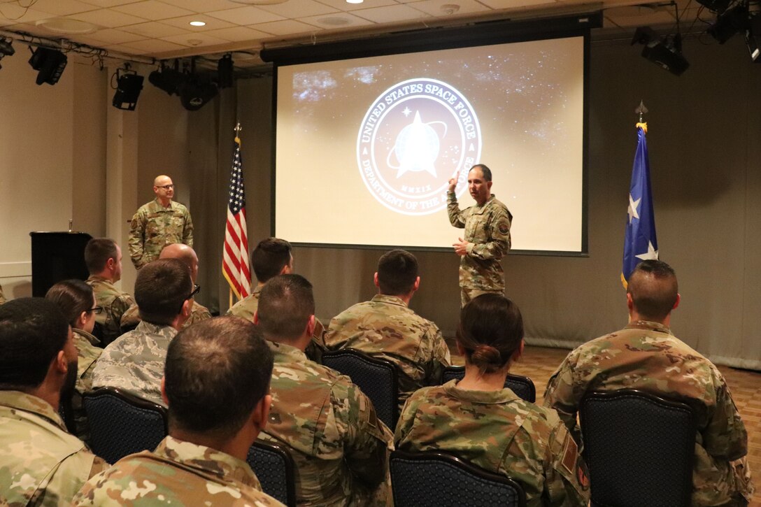 Photo of Major General Shaw briefing a group of Airmen.