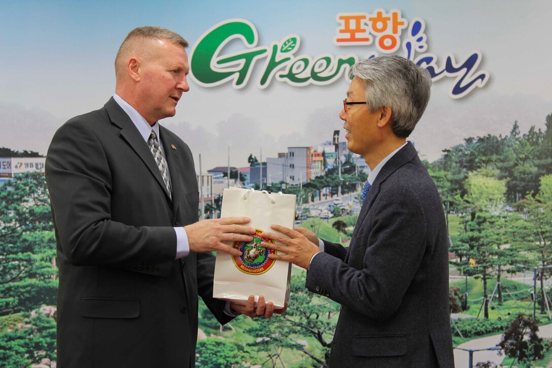 Maj. Gen. Bradley S. James gives a gift to Pohang Vice Mayor Song Kyeong Change, on the behalf of U.S. Marine Corps Forces Korea. The two gentlemen met to discuss the future relationship and unity between the City and U.S. Marines. (U.S. Marine Corps Photo by Sgt. Parker R. Golz)