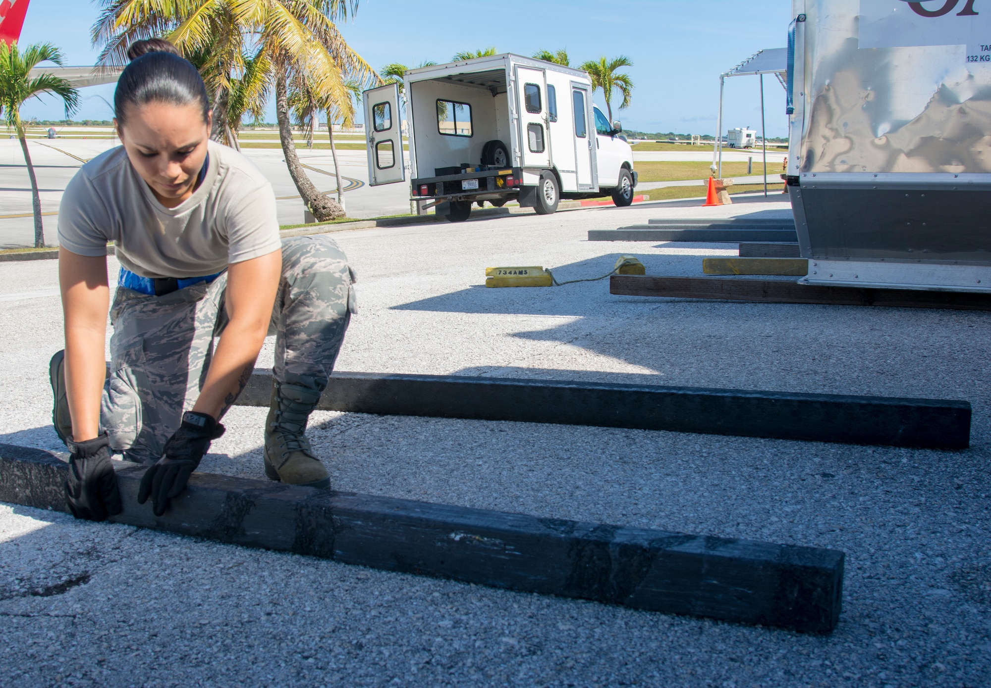 Picture of U.S. Air Force Airman 1st Class Camarin Perez, 44th Aerial Port Squadron transportation specialist, placing floor dunnage on the ground for cargo bins in support of the first Patriot Express mission to arrive at Andersen Air Force Base, Guam, March 7, 2020.