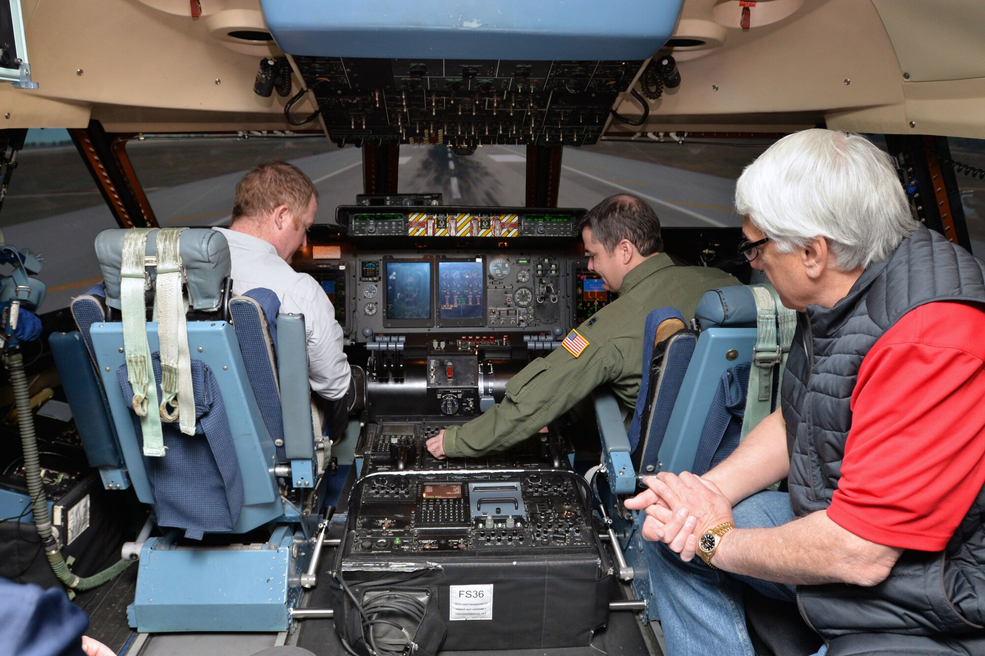 Lt. Col. Ryan A. Clark, 356th Airlift Squadron flight instructor, describes C-5M Super Galaxy flight deck controls to Rich Weimert, San Antonio Missions Baseball director of baseball operations (left), and Craig Veltri, Office Resource Center president March 7, 2020 at Joint Base San Antonio-Lackland, Texas. Weimert and Veltri are 433rd Airlift Wing honorary commanders, who along with other honorary commanders toured the 433rd Operations Group.