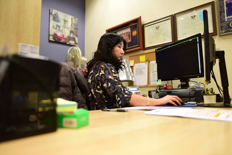 Sang Ju Yi, Passport Agent at the 31st Force Support Squadron Passport Office, navigates her computer desktop in the at Aviano Air Base, Italy, Feb. 27, 2020. Yi has worked in the Passport Office for close to four years. (U.S. Air Force photo by Tech. Sgt. Tory Cusimano)
