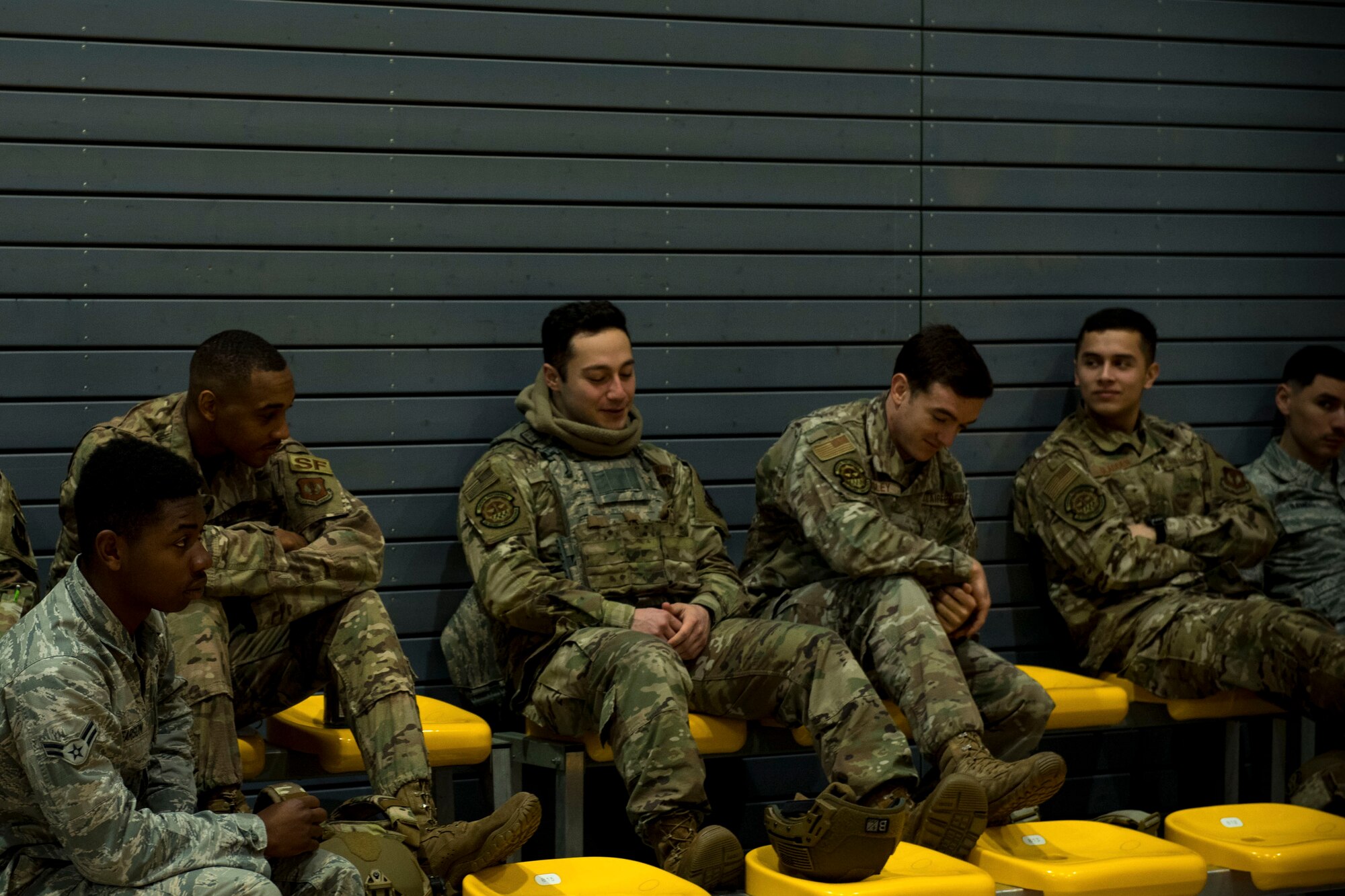 U.S. Air Force security forces members gather in the gym preparing for their ruck march.