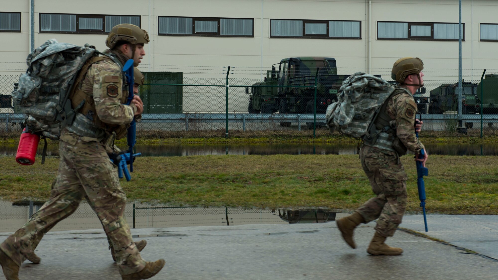 U.S. Air Force security forces members are rucking down the road.