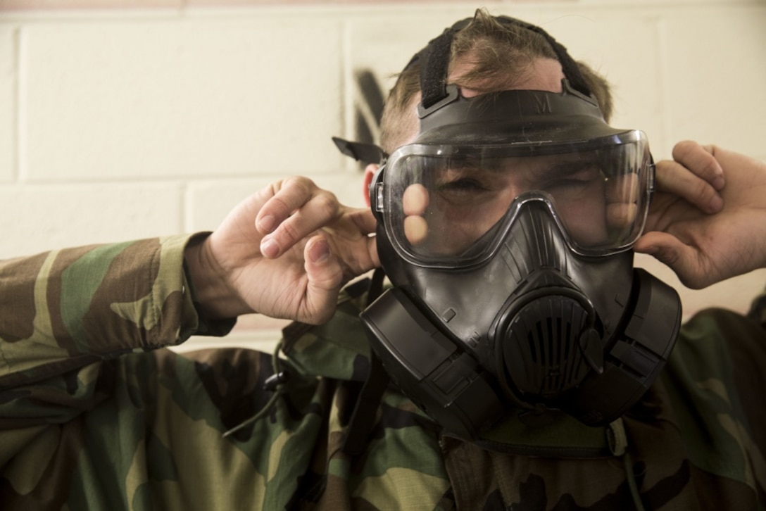 A Marine with the 24th Marine Expeditionary Unit breaks the seal of his M50 Joint Service General Purpose Mask during the Individual Protective Equipment Confidence Exercise on Camp Lejeune, North Carolina, February 14, 2020. Marines participate in this training to stay proficient with their mask in case they are exposed to a contaminated environment. (U.S. Marine Corps photo by Cpl. Margaret Gale)