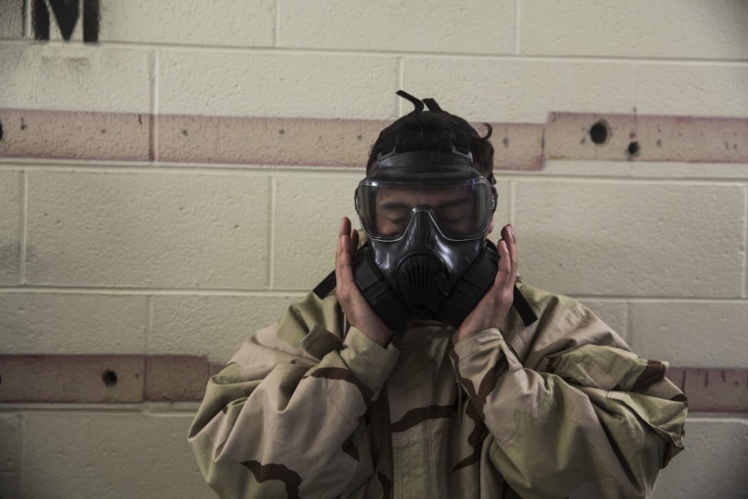 Corporal Heriberto Nunez, an administrative specialist with the 24th Marine Expeditionary Unit, clears his M50 Joint Service General Purpose Mask during the Individual Protective Equipment Confidence Exercise on Camp Lejeune, North Carolina, February 14, 2020. Marines participate in this training to stay proficient with their mask in case they are exposed to a contaminated environment. (U.S. Marine Corps photo by Cpl. Margaret Gale)