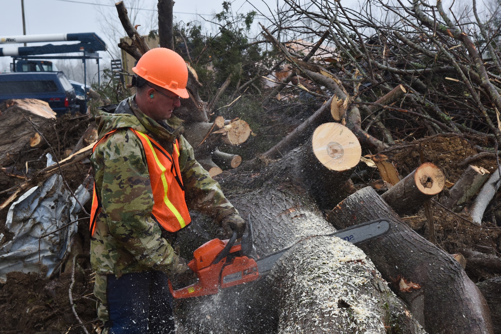 A Tennessee Air National Guard member with the 134th Air Refueling Wing uses a chainsaw March 10, 2020, in Cookeville as part of a debris clearing operation. Both Air and Army National Guard members are conducting multiple operations throughout the state to aid in disaster relief efforts, after tornadoes ravaged central Tennessee March 3.