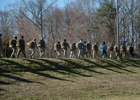 Members of the 459th Security Forces Squadron participate in a ruck march during Unit Training Assembly weekend, March 7, 2020, at Joint Base Andrews, Md. The unit participated in the march as part of their physical fitness training. (U.S Air Force photo/SrA Andreaa Phillips)