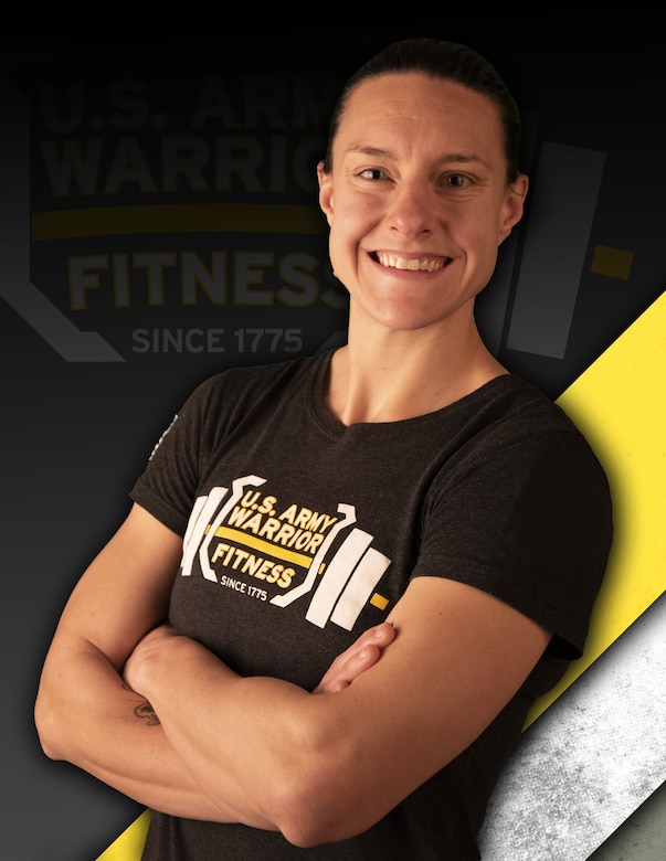 white female with crossed arms in gray and yellow and white t-shirt with a barbell on it in front of a black, yellow and white backgrou.