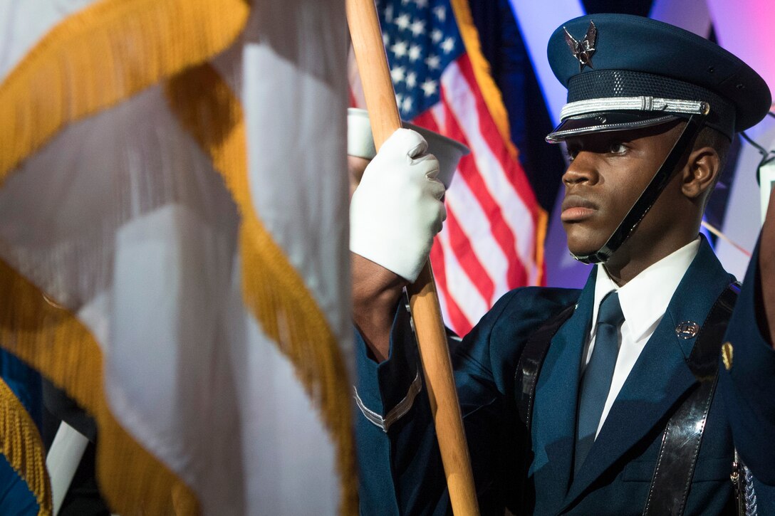 An airman holds a flag.