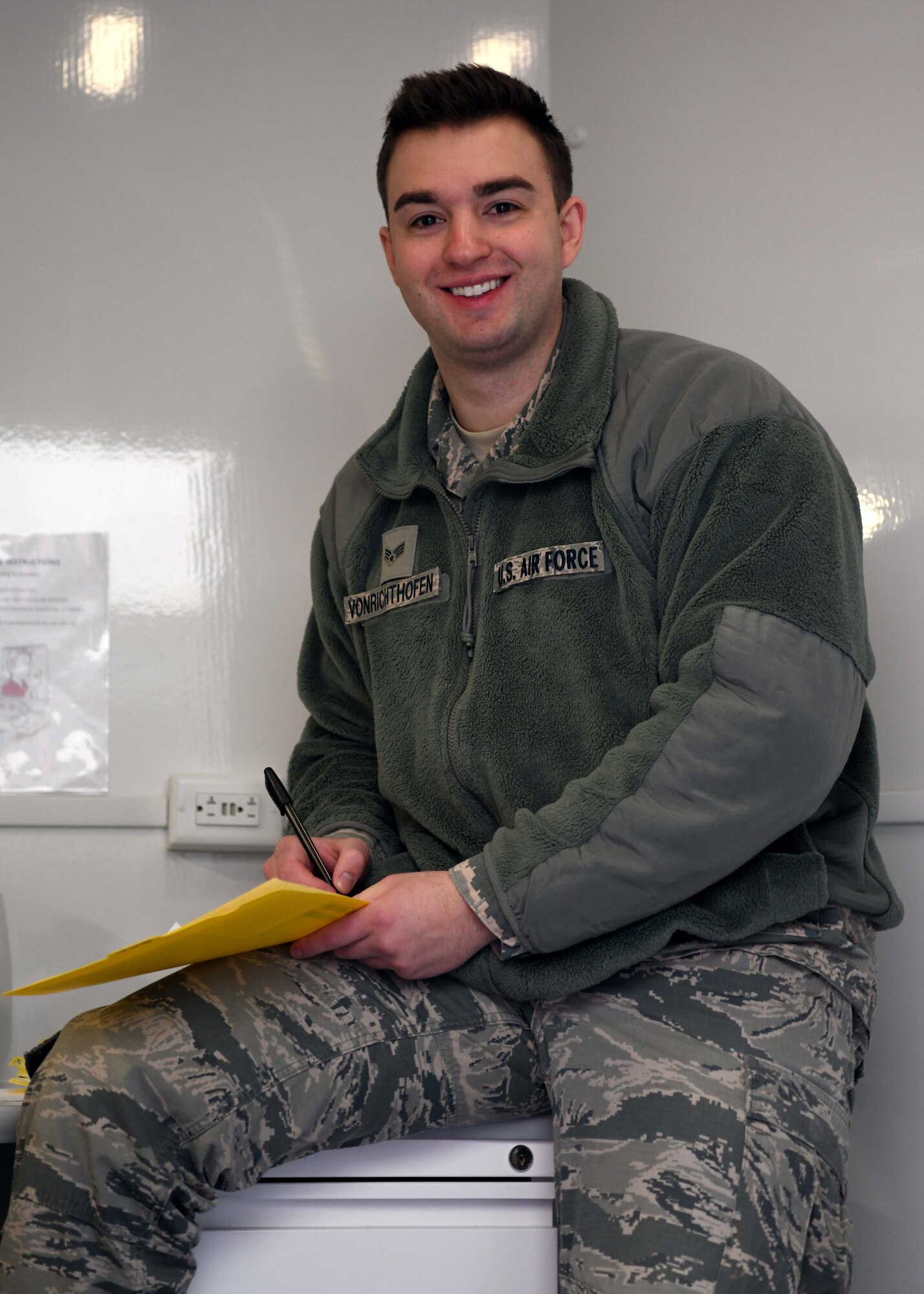 Senior Airman Austin VonRichthofen helps to administer hearing tests as part of the 104th Fighter Wing's Periodic Health Assessments on March 7, 2020. The PHA is a screening tool used to evaluate the individual medical readiness of service members. (U.S. Air National Guard photo by Airman Camille Lienau)