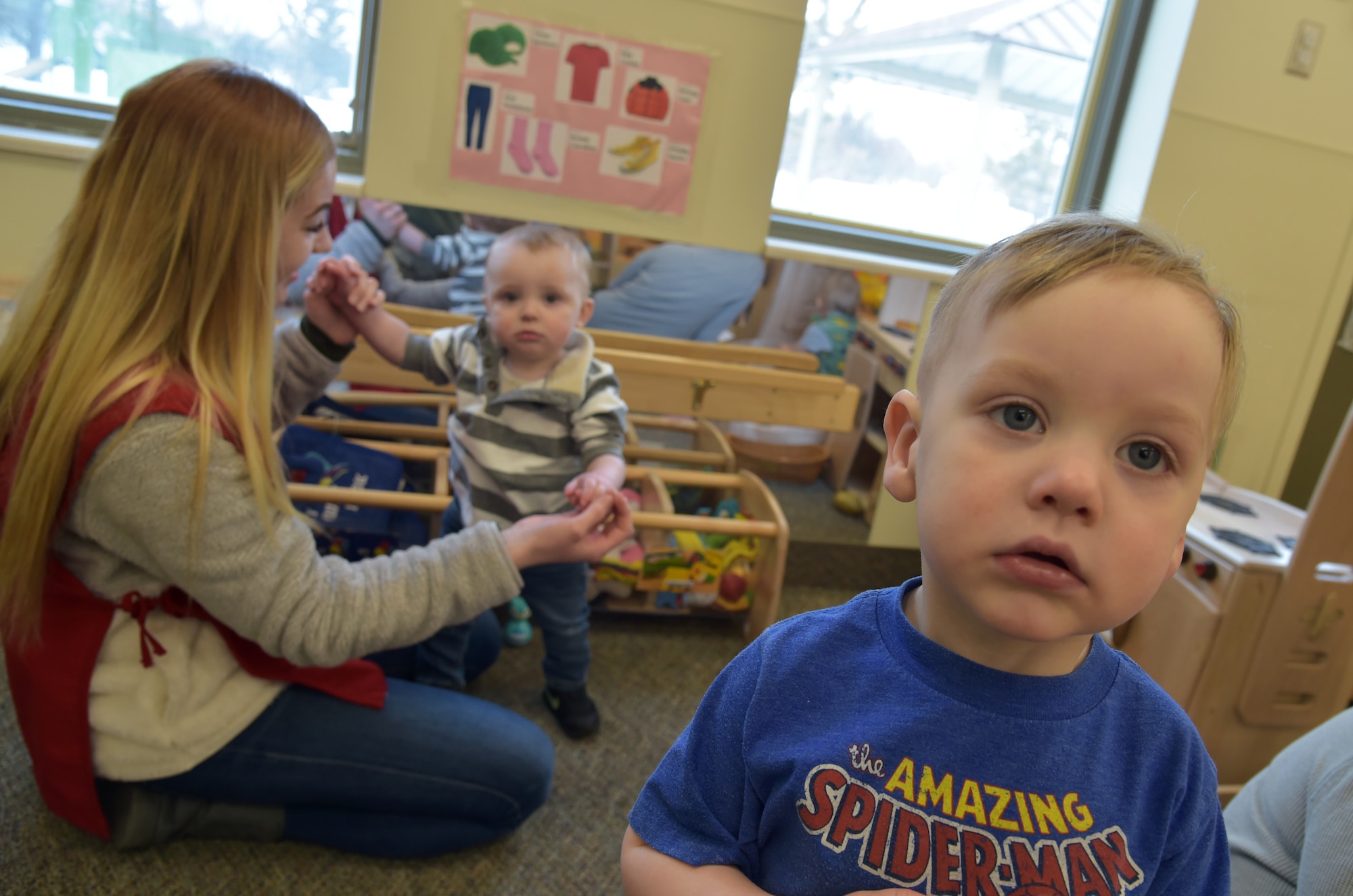 A toddler poses for a photo at the Child Development Center on Grand Forks Air Force Base, N.D., March 10, 2020. Effective 1 April, the CDC will change its hours to open at 0700 and will close at 1730. The change is necessary to allow for mandated scheduled breaks for caregivers, curriculum planning and establishes continuity of caregivers in the classrooms. (U.S. Air Force photo by Tech. Sgt. Kamaile Casillas)