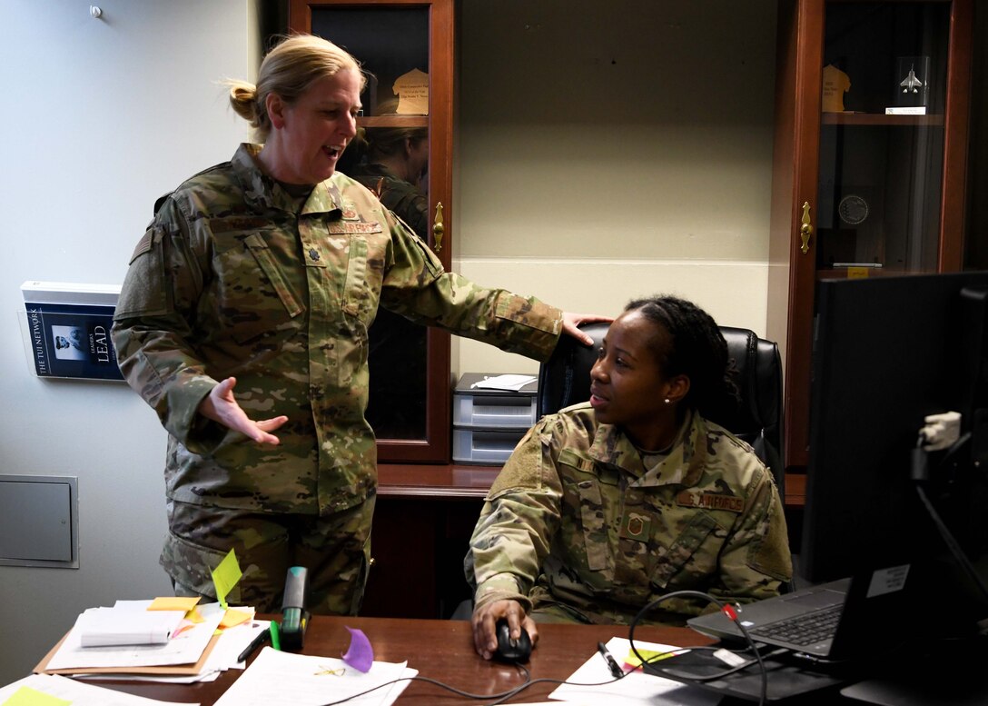 Lieutenant Colonel Wendy Kiepke works with Master Sgt. Neisha Nixon to ensure service members get paid. Kiepke oversees finances for the base and advises commanders on how to budget appropriately. (U.S. Air National Guard photo by Airman Camille Lienau)
