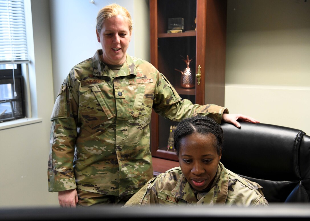Lieutenant Colonel Wendy Kiepke works with Master Sgt. Neisha Nixon to ensure service members get paid. Kiepke oversees finances for the base and advises commanders on how to budget appropriately. (U.S. Air National Guard photo by Airman Camille Lienau)