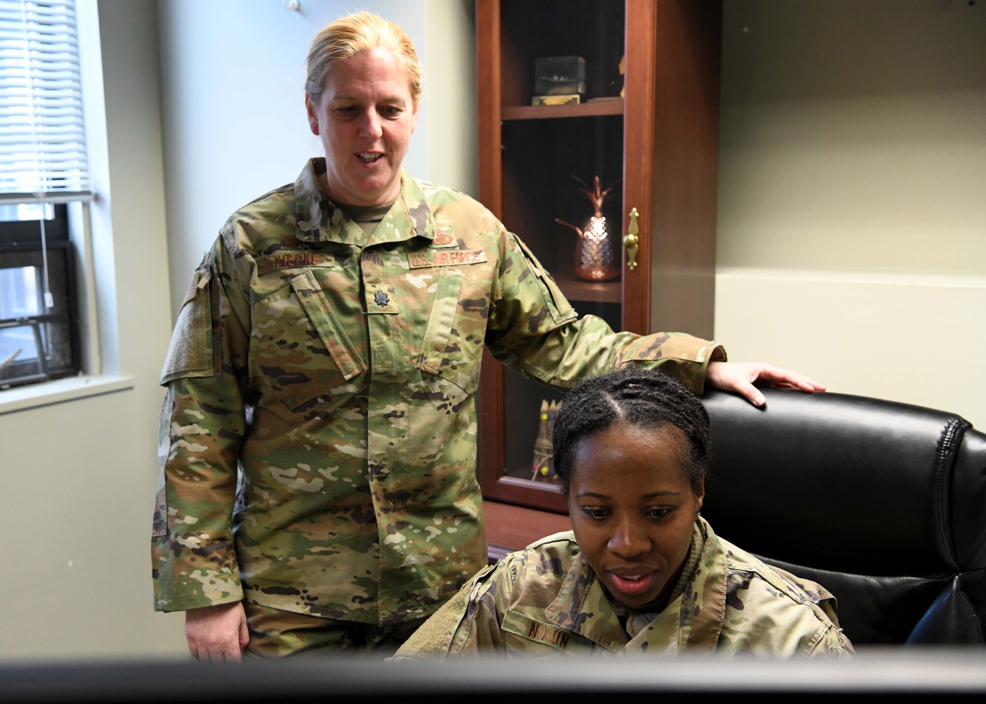 Lieutenant Colonel Wendy Kiepke works with Master Sgt. Neisha Nixon to ensure service members get paid. Kiepke oversees finances for the base and advises commanders on how to budget appropriately. (U.S. Air National Guard photo by Airman Camille Lienau)