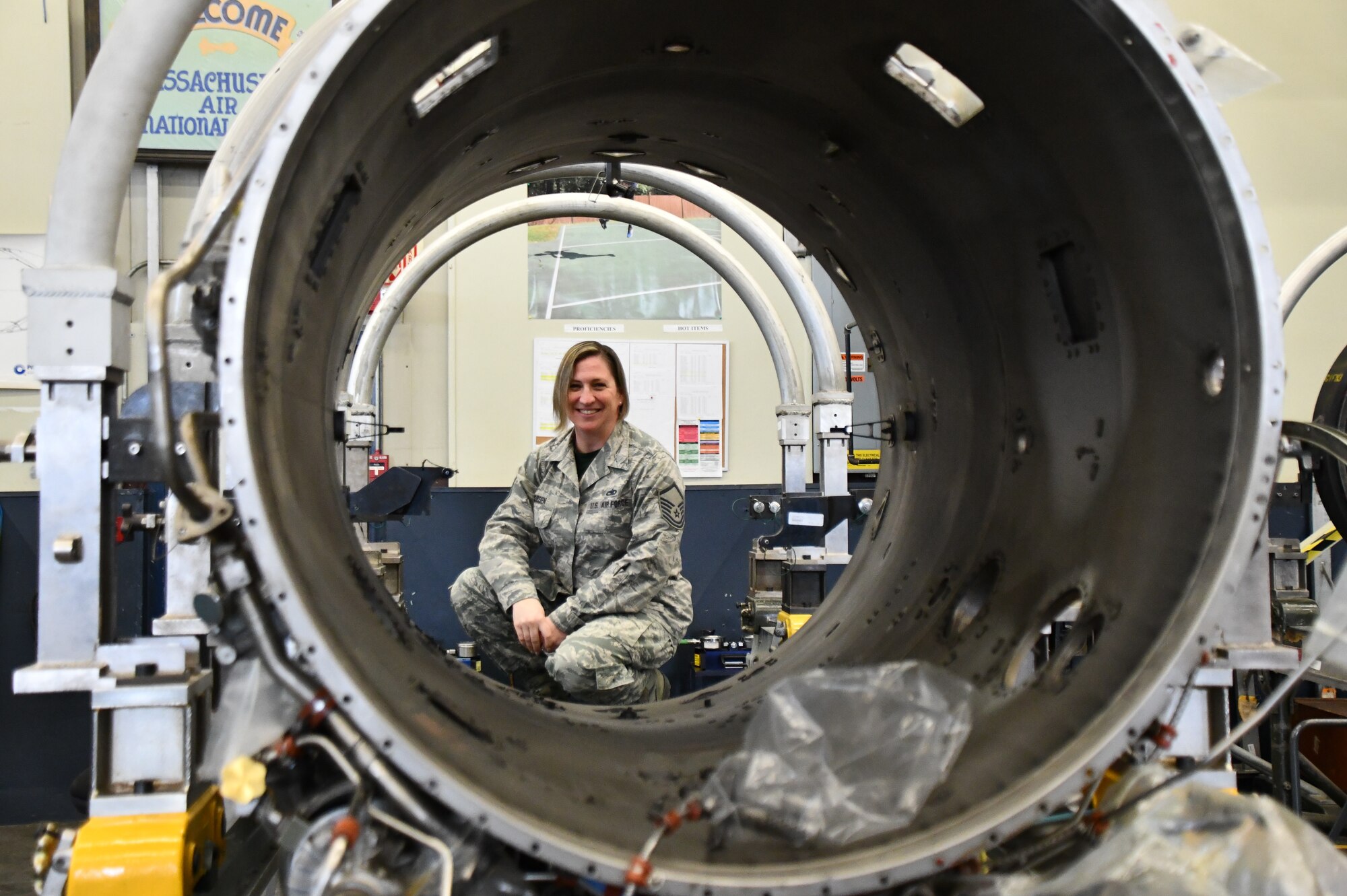 Master Sgt. Sara Jean Jacobsen, 104th Maintenance Group engine manager, looks through a F-15 Eagle engine duct, March 7, 2020, at Barnes Air National Guard Base, Massachusetts. Jacobsen enlisted at the 104th Fighter Wing over 20 years ago and said that Barnestormers strive to be the best at everything they do which leads to their success.  (U.S. National Guard Picture by Airman Basic Sara Kolinski)
