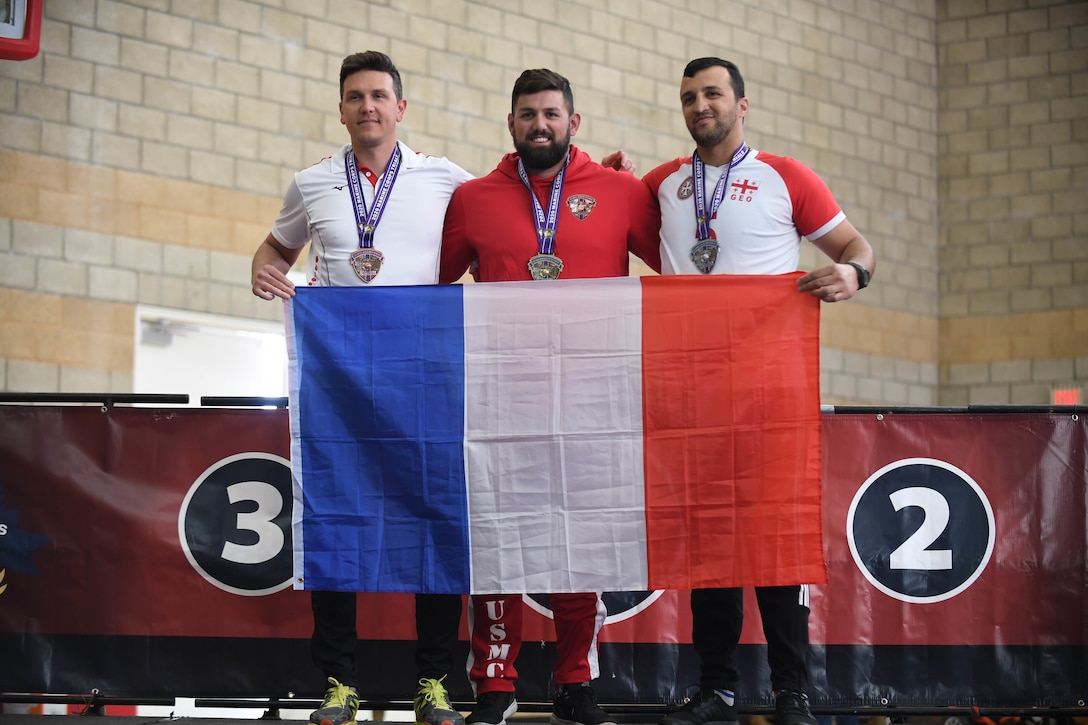Athletes Matthieu Talliez, left, Michael Sousadecarmo, center, and Sandro Khujadze, right, win the bronze, silver, and gold medals, respectively, for the male 5.5 rowing finals during the 2020 Marine Corps Trials at Marine Corps Base Camp Pendleton, Calif., March 9.