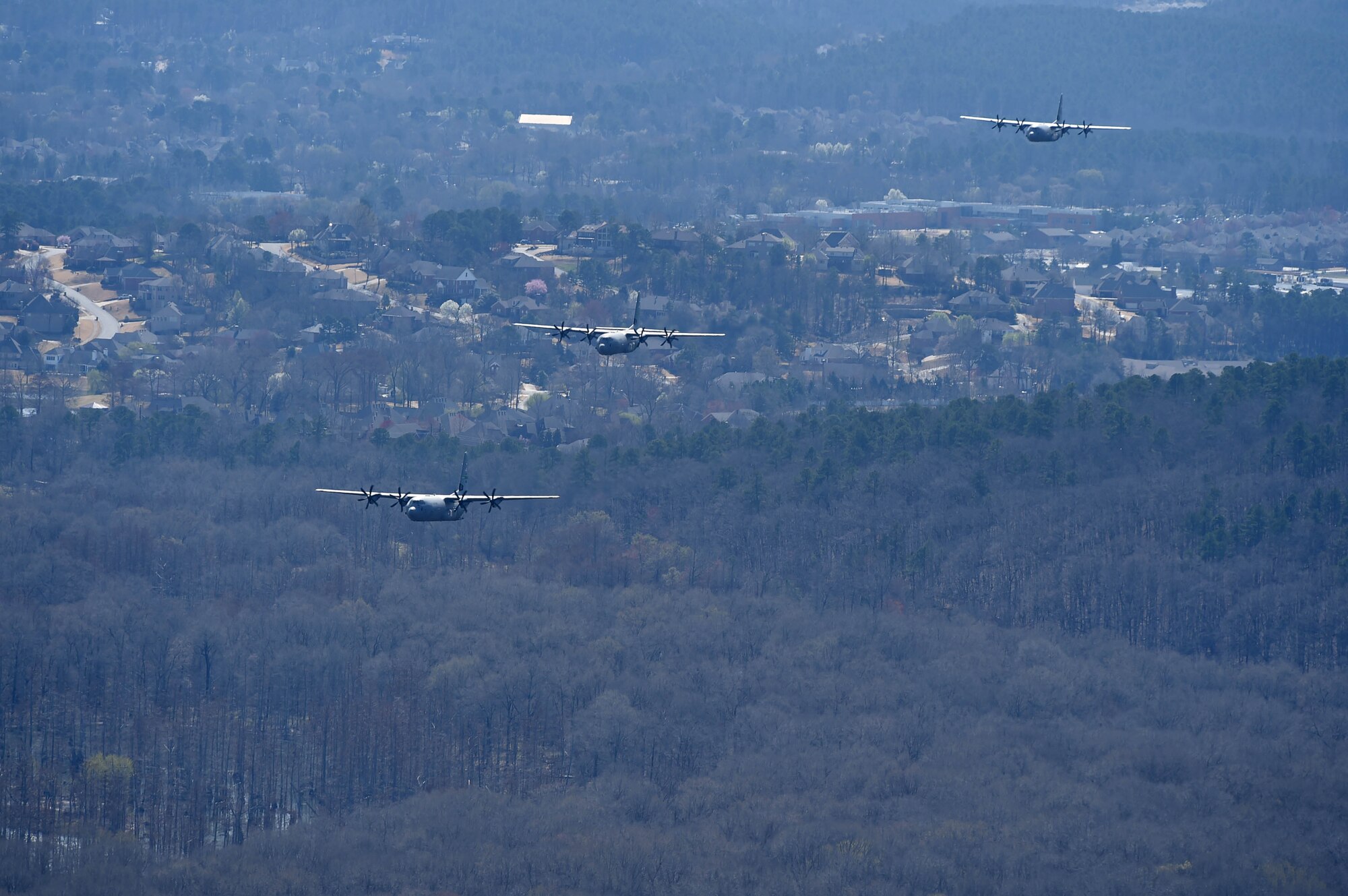 The aircraft flying in formation along a river.