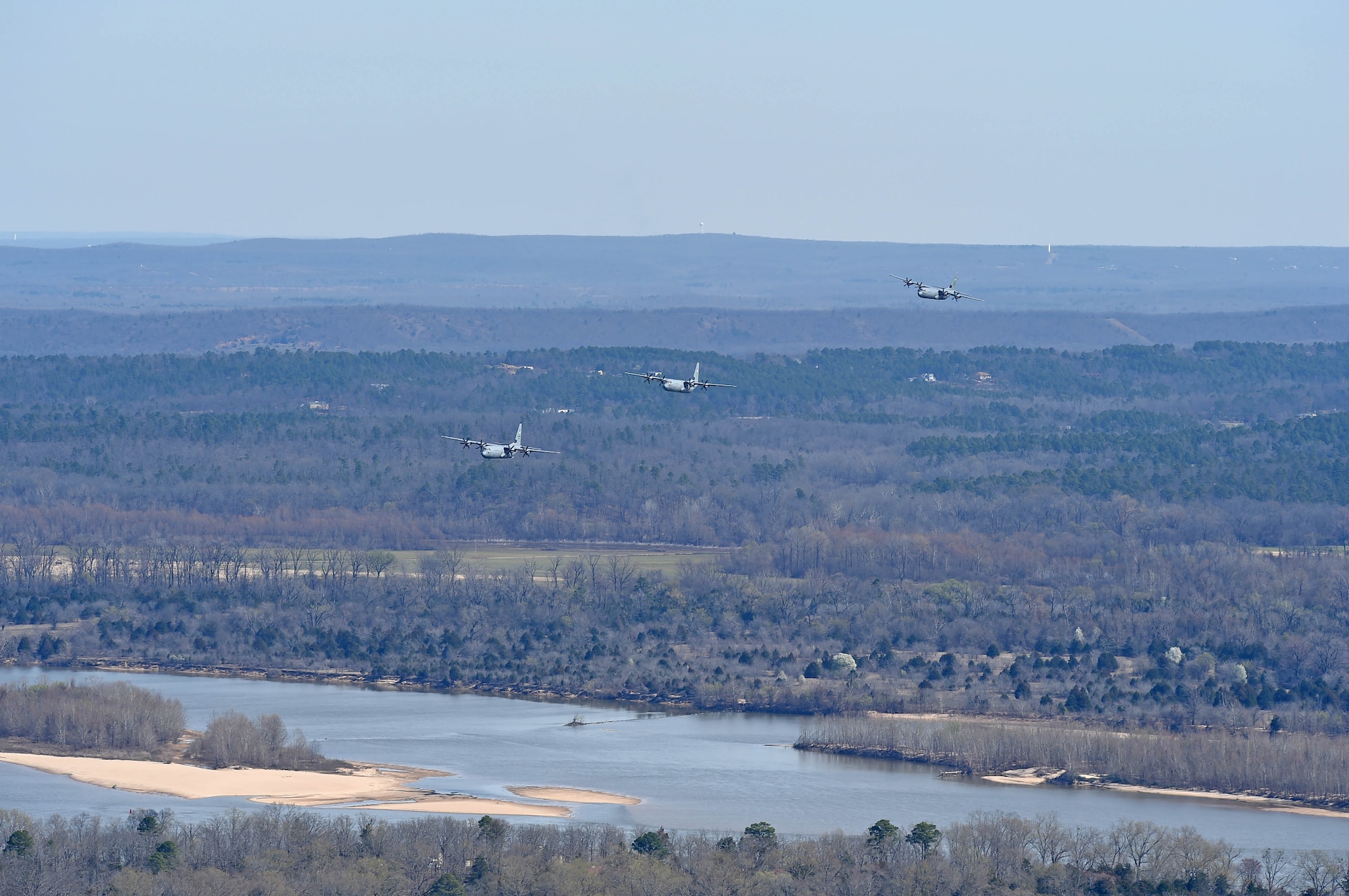 The aircraft flying in formation along a river.