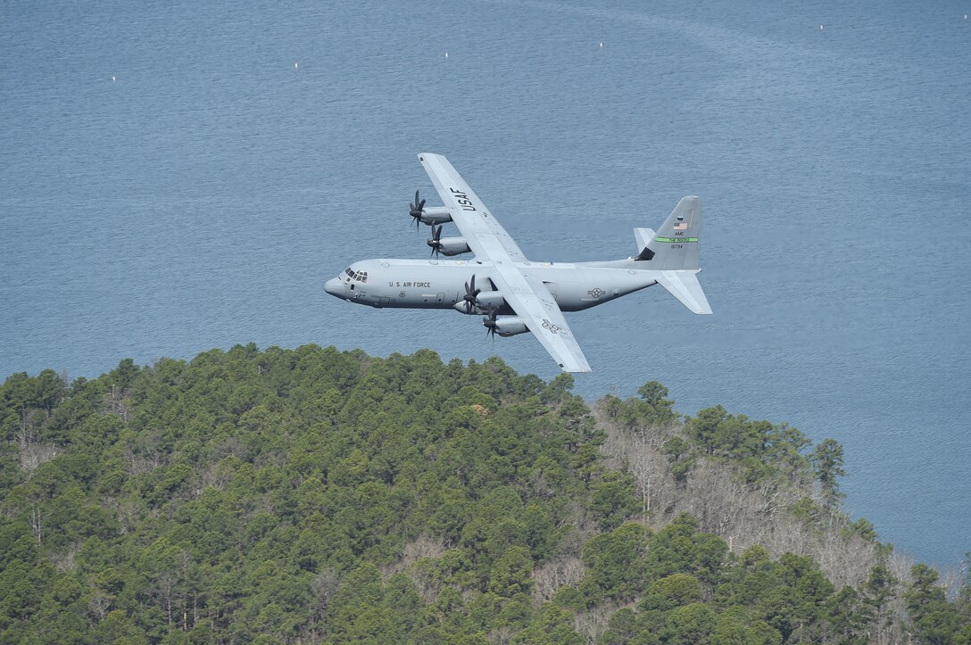 The aircraft flying in formation along a river.