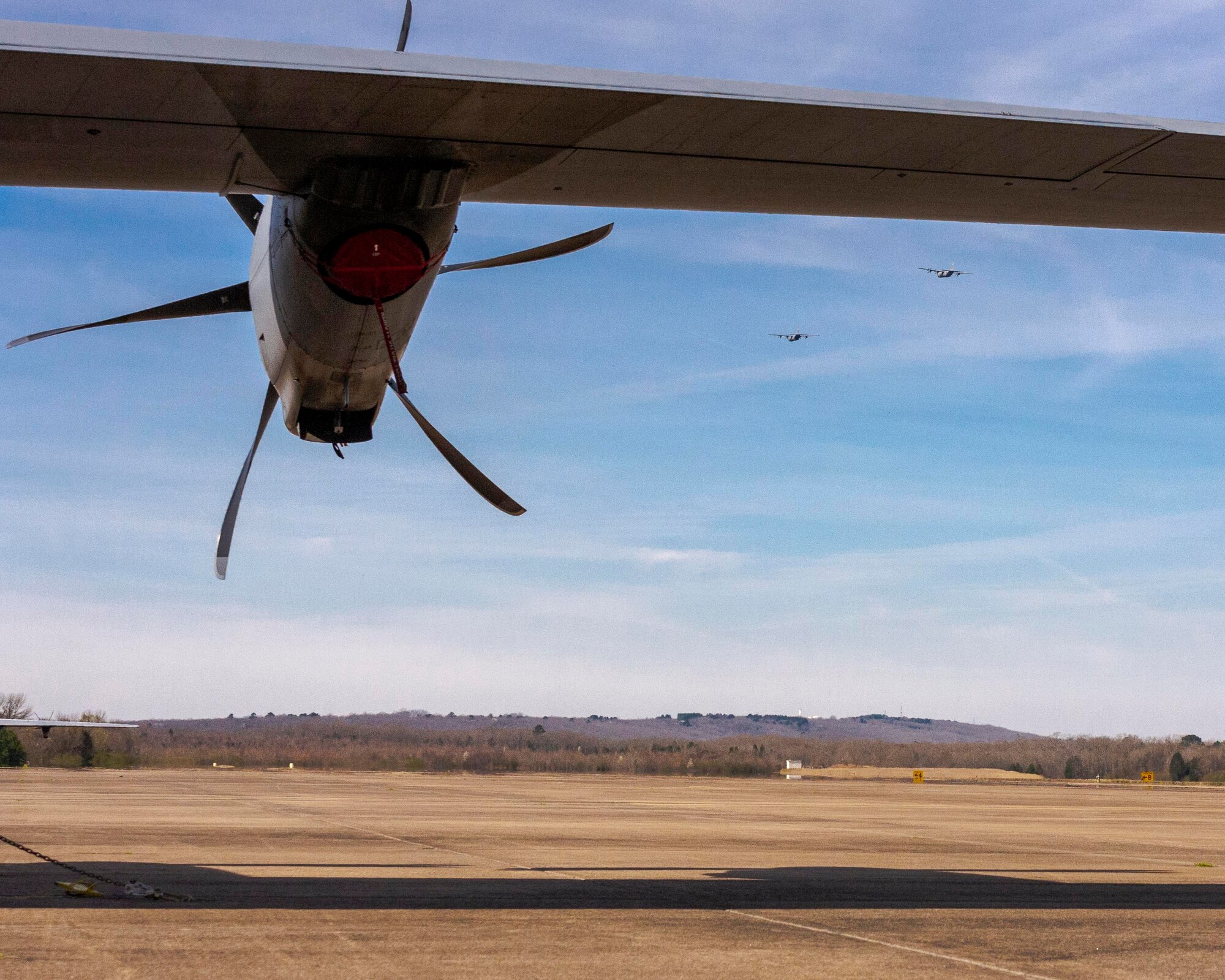 Two C-130J aircraft taking off from runway