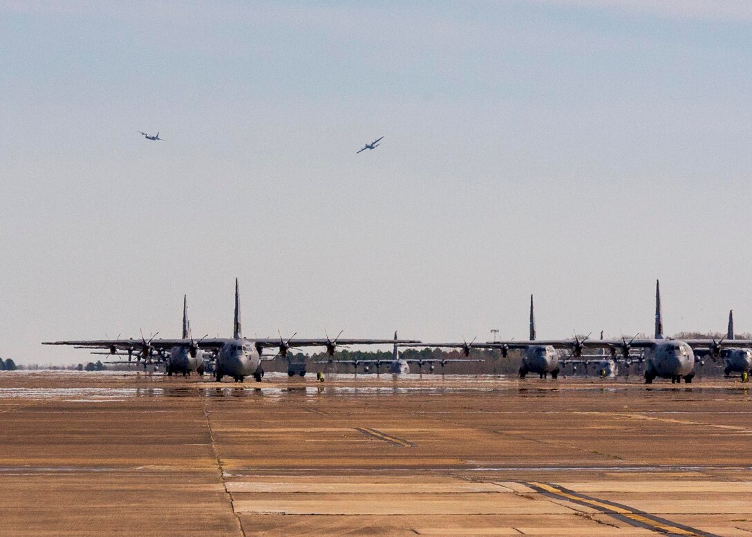 Two C-130J Hercules taxi from the runway at Little Rock Air Force Base, Ark. March 7, 2020.