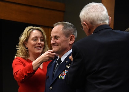 Wife, Cindy and dad, John, pin new rank on newly promoted Brig. Gen. James Silvasy, of Gurnee, Illinois, Illinois Air National Guard Chief of Staff, during a promotion ceremony March 8 at the Illinois Military Academy, Camp Lincoln, Springfield, Illinois.