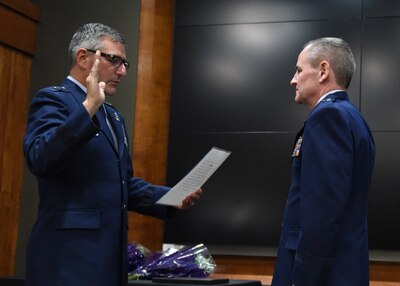 Brig. Gen. Peter Nezamis, Assistant Adjutant General-Air, Illinois National Guard, administers the oath of office to newly promoted Brig. Gen. James Silvasy, of Gurnee, Illinois, Illinois Air National Guard Chief of Staff, during a promotion ceremony March 8 at the Illinois Military Academy, Camp Lincoln, Springfield, Illinois.