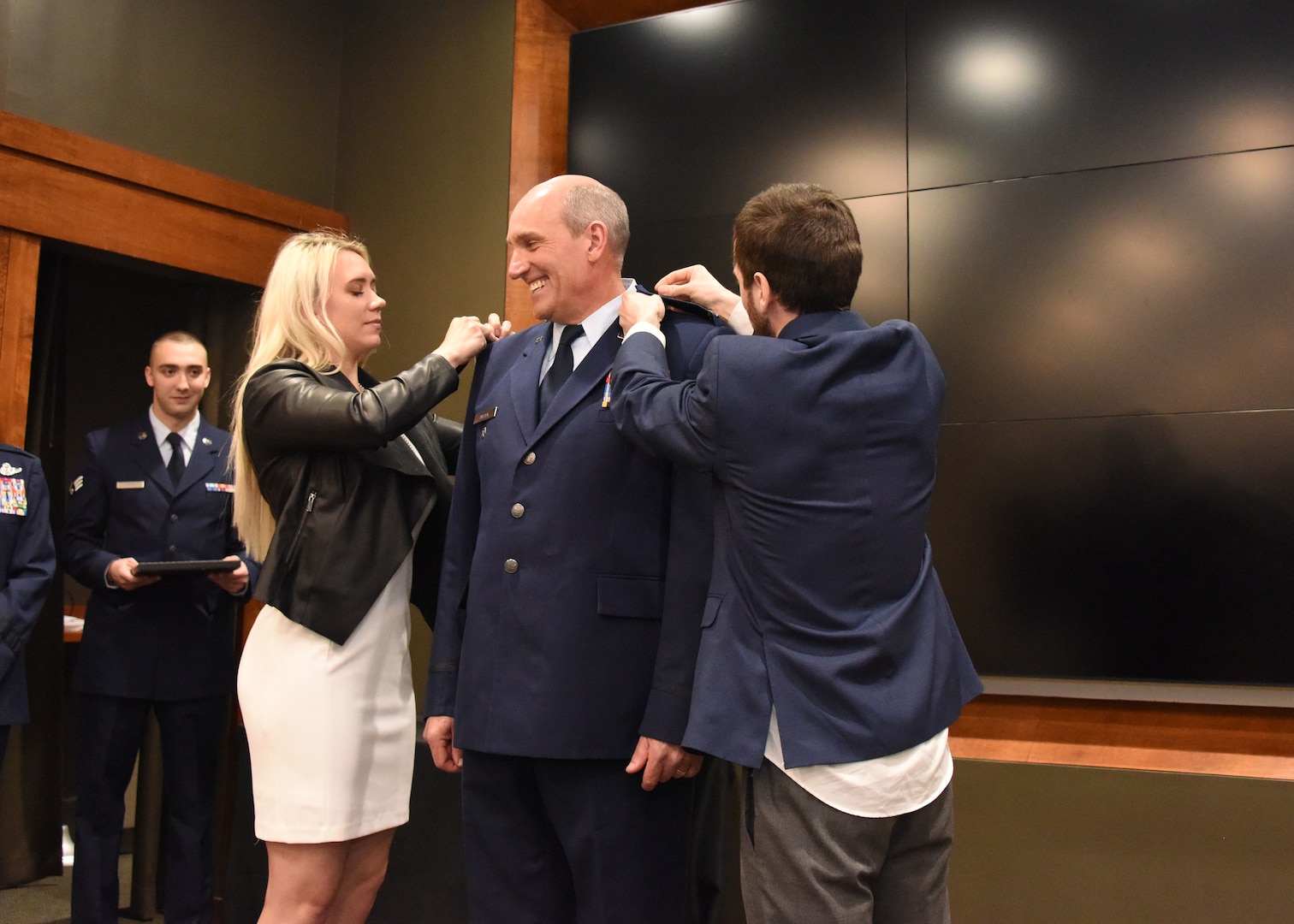 Daughter, Monica and son, Alex, pin eagles on newly promoted Illinois Air National Guard Col. William Miller, Director of Staff-Air, during a promotion ceremony March 8 at the Illinois Military Academy, Camp Lincoln, Springfield, Illinois.