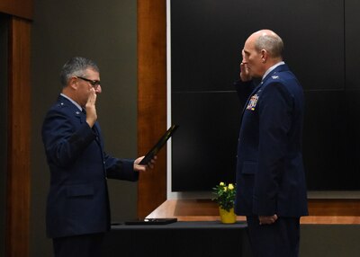 Brig. Gen. Peter Nezamis, Assistant Adjutant General-Air, Illinois National Guard, administers the oath of office to newly promoted Col. William Miller, Director of Staff-Air, Illinois Air National Guard, during a promotion ceremony March 8 at the Illinois Military Academy, Camp Lincoln, Springfield, Illinois.