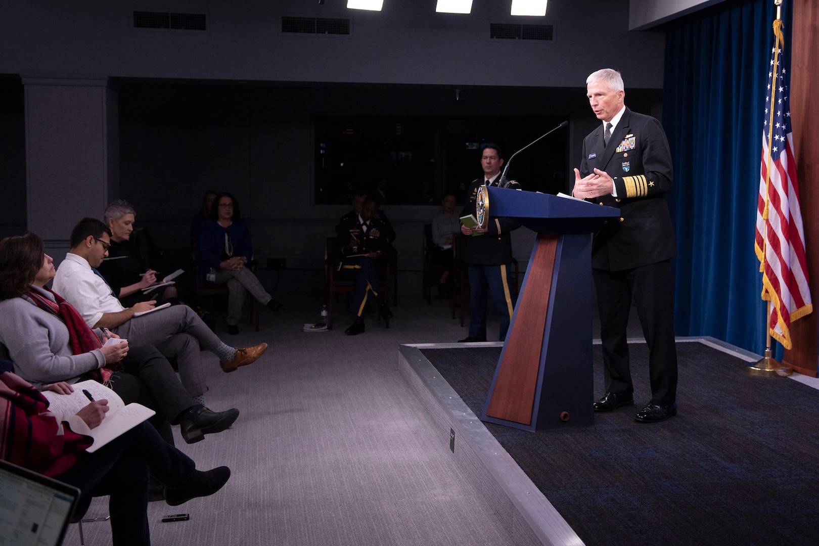 Adm.Craig S. Faller speaks at a podium.