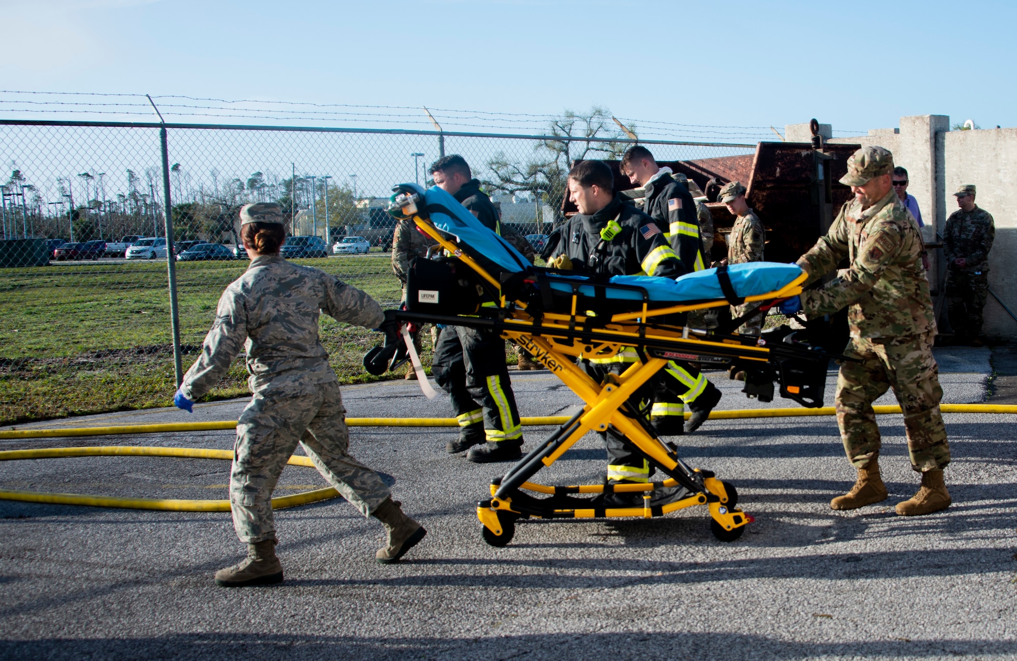 Senior Airman Ashley Deliz Aguilera, left, and Tech. Sgt. Wallace Boatright, right, 325th Operational Medical Readiness Squadron Ambulance Services Department technicians, move a stretcher for patient transfer during an exercise at Tyndall Air Force Base, Florida, March 12, 2020. The base participated in a joint exercise which included serval units from Tyndall and local emergency responders. The collaboration served to strengthen community relations and proper patient care during a medical emergency on base. (U.S. Air Force photo by 2nd Lt. Kayla Fitzgerald)