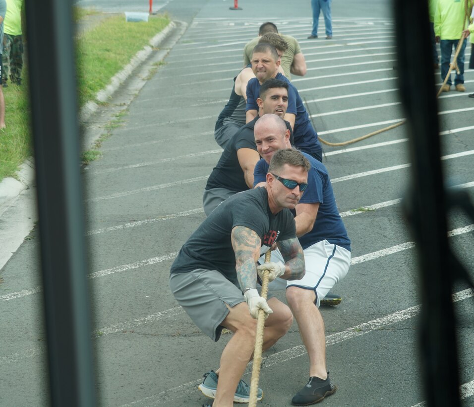 U.S. Sailors from the Commander, Submarine Force, U.S. Pacific Fleet pull a bus as part of the Toughest Warrior Competition on Joint Base Pearl Harbor-Hickam, Hawaii, March 9, 2020. The week-long event, comprised of six-person teams from various commands, includes physical, critical thinking and team-building challenges held at different locations throughout JBPHH. (U.S. Air Force photo by Staff Sgt. Nicholas Brown)