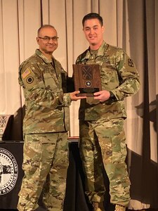 Sgt. Robert O'Donnell, a crypto-linguist with Delta Company, 341st Military
Intelligence Battalion, Washington National Guard, is presented with the 2019 Language Professional of the Year award by Col. Shahram Takmili, commander of the 300th Military Intelligence Brigade, Utah National Guard, during the Military Intelligence Conference March 8, 2020, at Draper, Utah.