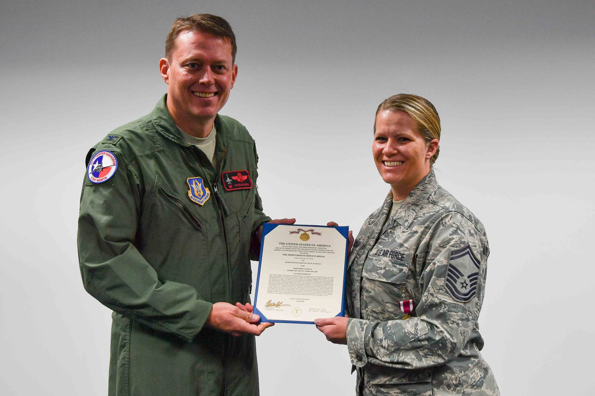 301st Fighter Wing Commander Col. Mitch Hanson presents Senior Master Sgt. Tia Kancilia, 301 FW Financial Management Senior Air Reserve Technician with a Meritorious Service Medal at U.S. Naval Air Station Joint Reserve Base Fort Worth, Texas. She was selected as the 2019 Air Force Reserve Command FM Senior Non-Commissioned Officer of the Year. (U.S. Air Force photo by Jeremy Roman)